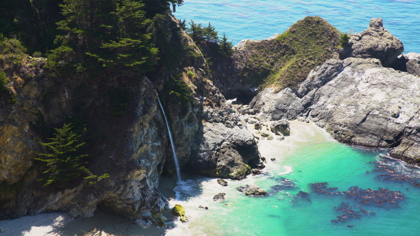 Telephoto shot of of McWay Falls at Julia Pfeiffer Burns State Park in Big Sur, California | Shutterstock HD Video #1055854130
