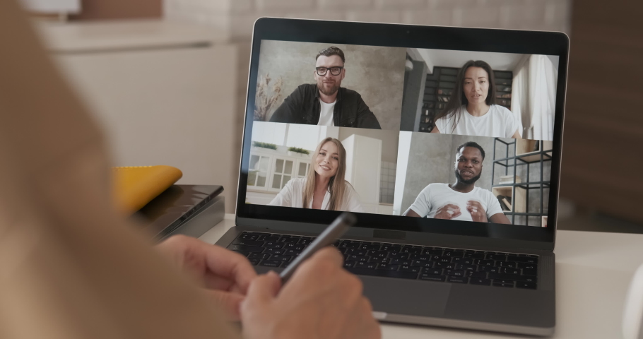 Discussing project online. Group video call. Remote communication of happy multiracial young people. Working from modern home office during pandemic. Business chat conference talking with teacher 4K Royalty-Free Stock Footage #1055858024
