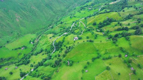Aerial view with a drone of the spring landscape of pasiegas cabins and meadows in the Miera Valley in the Autonomous Community of Cantabria. Spain, Europe