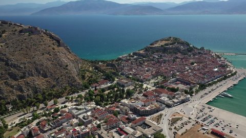 Aerial drone video of picturesque and historic old town of Nafplio in the slopes of Palamidi fortress and Acronafplia, Argolida, Peloponnese, Greece