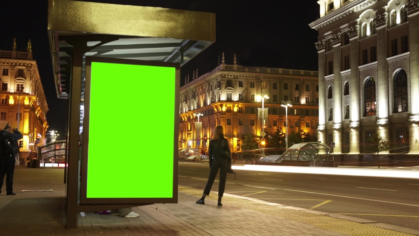 Billboard with a chroma key green screen on n bus stop at night. Time Lapse. | Shutterstock HD Video #1055871221