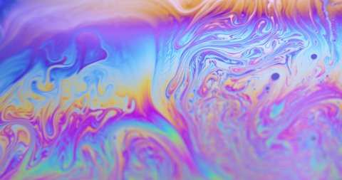 Surface of Liquid Soap with Changing Rainbow Colours. Macro.