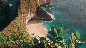 Azure beach with rocky mountains and clear water of Indian ocean at sunny day / A view of a cliff in Bali Indonesia / Bali, Indonesia