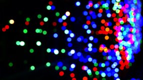 Bokeh from the festive illumination at night. Abstract bokeh background of Christmas night, outdoor. Round colorful bokeh Shine in the dark, 4K Video