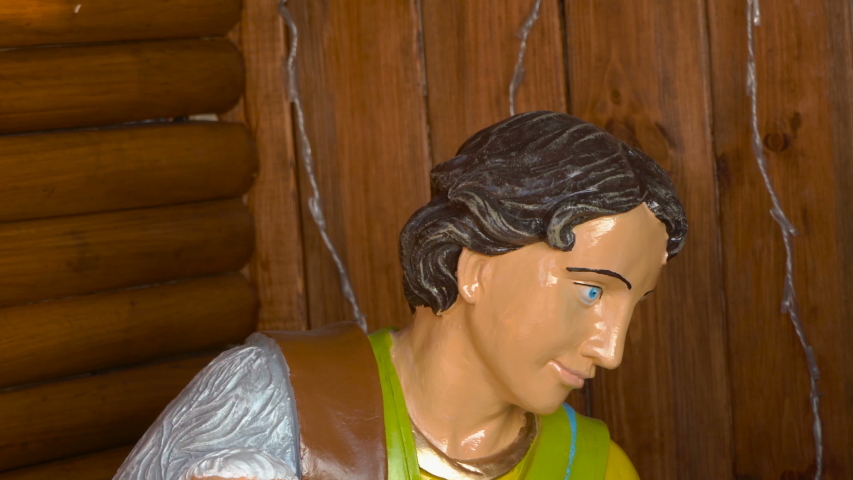 figurine of a shepherd with a lamb,close up of a man shepherd in his arms with a lamb Christmas figurine