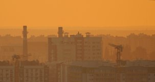 Beautiful video of cityscape at sunset. High-rise buildings with yellow sunlight, many textured skyscrapers. Video for cityscape background.