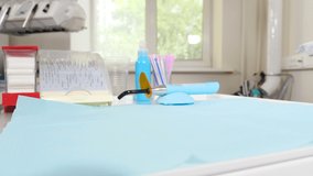 Dentist office. Tooth treatment. Close-up shot of female dentist in latex gloves preparing to work, opening craft package with dental sterile tools. In dental clinic. 4 k video