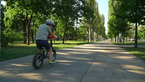 boy riding a bicycle in a park