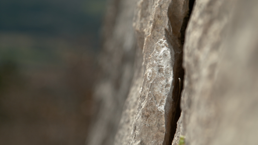SLOW MOTION, MACRO, DOF: White magnesium powder flies in the air as rock climber scales a cliff and places her fingers into a small crack. Woman grabs an edge hold while scaling a challenging cliff. Royalty-Free Stock Footage #1055905478