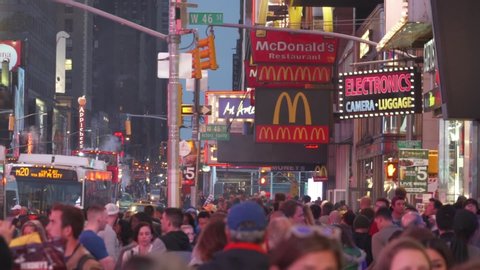 Manhattan, New York, United States of America - CIRCA 2019: Times Square NYC USA Commercial Intersection, Tourist Destination, Entertainment Center, Crowd of People, McDonald's Signage Americans