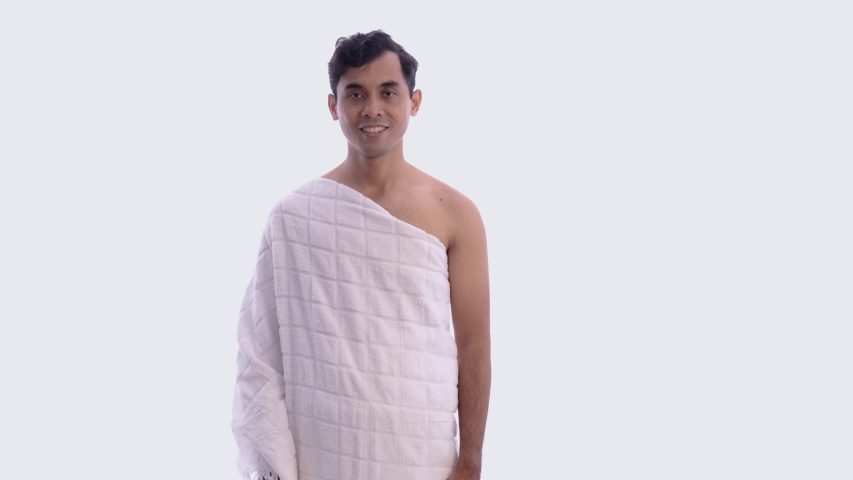asian male with ihram presenting copyspace. hajj and umrah man concept