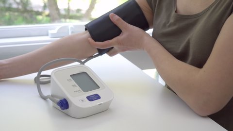 4k motorized jib shot of checking blood pressure at home