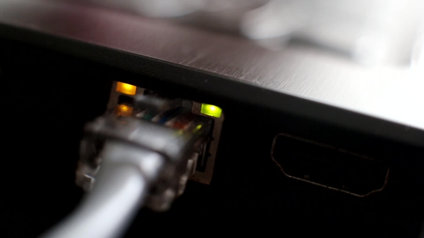 Connecting a laptop computer notebook to the Internet through a network ethernet ADSL cable, close-up. Local network card, LAN Royalty-Free Stock Footage #1055916410