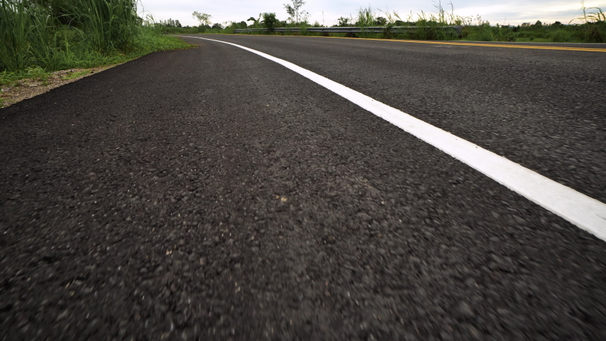 Front pov view of fast car driving on asphalt road
 | Shutterstock HD Video #1055917250