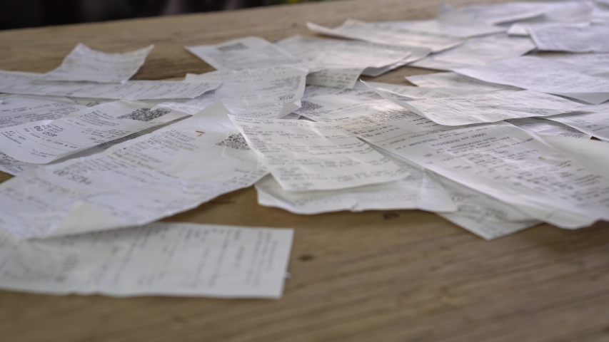 A heap of supermarket paper receipts. Shopping receipts, cash register, expenses, home finance, personal finance, money spending. Unconscious consumption Royalty-Free Stock Footage #1055924006