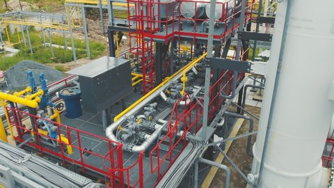 Aerial view Gas production station. Metal construction with valves on the pipes. Distribution and equipment for gas production.