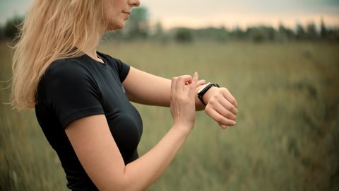 Heart Rate Smart Watch.Runner Checking Pulse On Smartwatch On Recreation Running Workout.Fit Woman Jogging Checking Pace On Smart Watch.Runner Using Smart Band.Run Girl Check Pulse On Fitness Bracelet