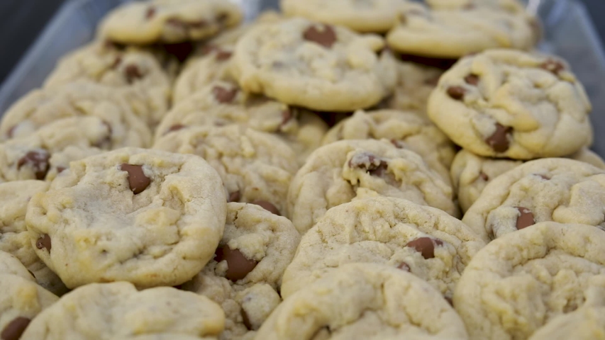 Pile Of Freshly Baked Chocolate Chip Cookies. - close up shot Royalty-Free Stock Footage #1055935526