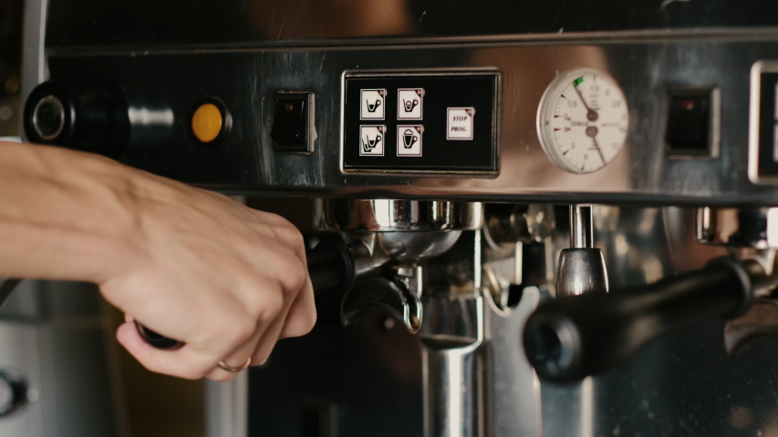 Process of making espresso in a coffee machine. Barista making latte in  specialty coffee shop. 
 | Shutterstock HD Video #1055939468