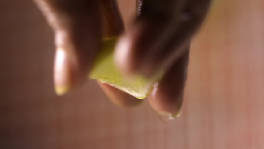 Closeup shot of hand squeezing lemon.Lemon juice coming out of lemon.