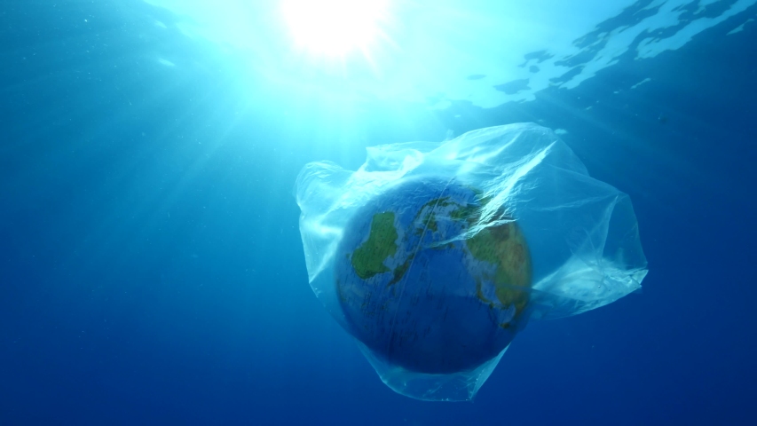 world in plastic bag drifting underwater representing ocean pollution with sun beams and rays backgrounds Royalty-Free Stock Footage #1055954342