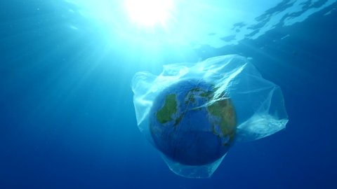 world in plastic bag drifting underwater representing ocean pollution with sun beams and rays backgrounds