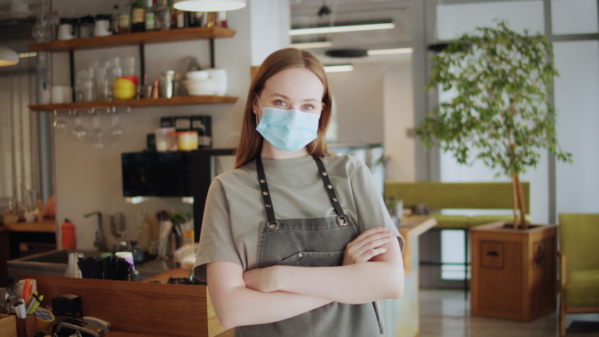 small business after covid, portrait of Coffee Shop restaurant Woman Owner in Face medical protection Mask, office worker, coronavirus Quarantine is over. Safety medical masks. Royalty-Free Stock Footage #1055958953