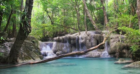 Seamless loop video of wild rain forest waterfall in tropical jungle of Thailand. Peaceful and beautiful nature background