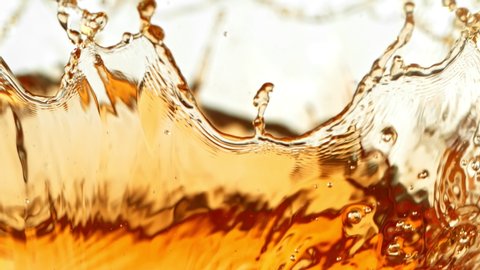 Super Slow Motion Shot of Brown Liquid Splash Isolated on White Background at 1000fps.