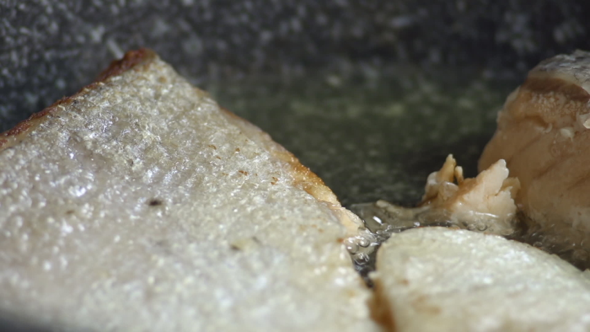 Close up of fresh salmon fillets in the frying pan
