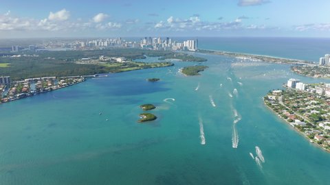 South Beach nature, Florida, USA. 4K aerial panorama of clean light-green sea waters in Miami bay. Residential front line buildings with beautiful Atlantic ocean view. Background for travel business