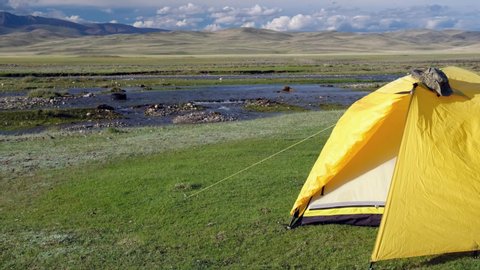 Video of tourist camping tent on the bank of Altai river Yustyt. Altai, Russia.