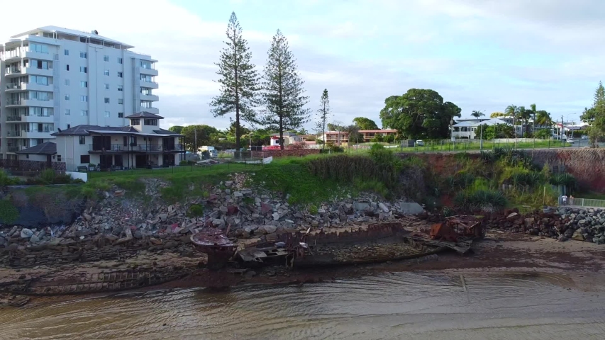 Residential area near the beach in Redcliffe Australia. Ruins of a ship on the shore the beach. 