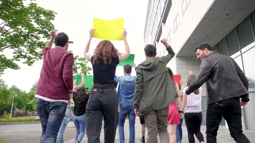 Slow motion shot of group of people with banners protesting