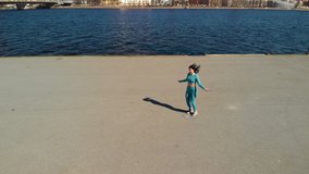 Brunette woman in sportswear exercises with jumping rope on sunny day aerial - Powered by Shutterstock - Get 15% off with code: PIKWIZARD15