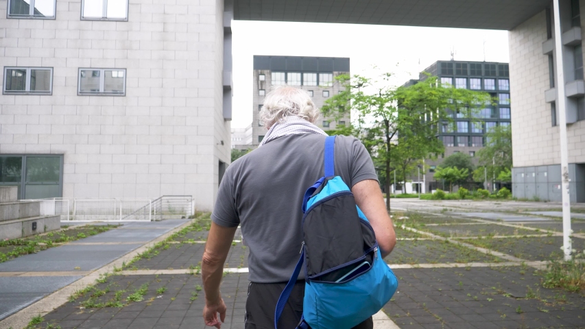 Slow motion shot of senior athletic man walking in city