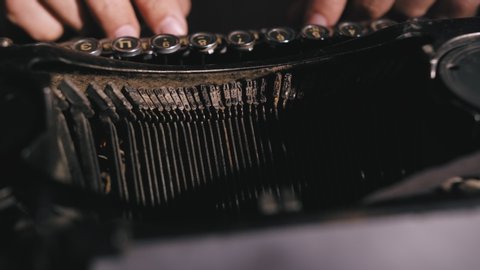 Male hands typing on vintage typewriter