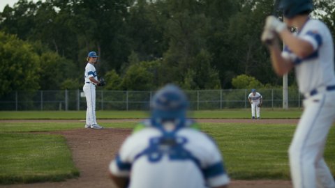 Swing for the fence. Baseball game in action. Pitcher throwing a ball down the middle. Competitive game perfect for playback. Shot in slow-motion and in 4k. 