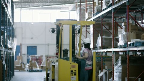 Forklift moves goods in ecommerce warehouse. Ready for shipping to online customers. 