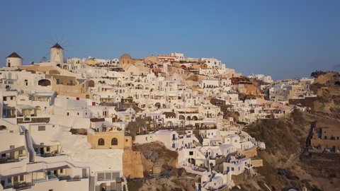 People watch for sunset on terraces of famous Oia town, Santorini island, Greece