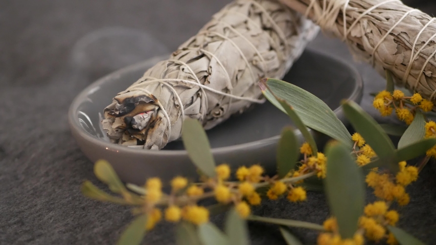 Dried white sage smudge stick, relaxation and aromatherapy. Smudging during psychic occult ceremony, herbal healing, yoga or aura cleaning. Essential incense for esoteric rituals and fortune telling. | Shutterstock HD Video #1055997911