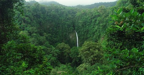 La Fortuna Waterfall in the rainforest near Arenal Volcano in Costa Rica, Central America. Beautiful nature landscape at toursit travel destination landmark.