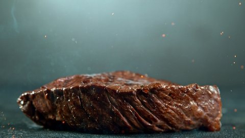 Close-up of falling tasty beef steak, super slow motion, filmed on high speed cinematic camera at 1000 fps.