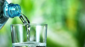 Super slow motion of pouring water from bottle into glass. Filmed at 1000 fps. - Powered by Shutterstock - Get 15% off with code: PIKWIZARD15