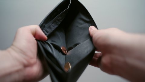 Unemployment during financial crisis, male opening black leather wallet, empty wallet and no paper currency. Wallet with coins inside, bankruptcy and poverty concept