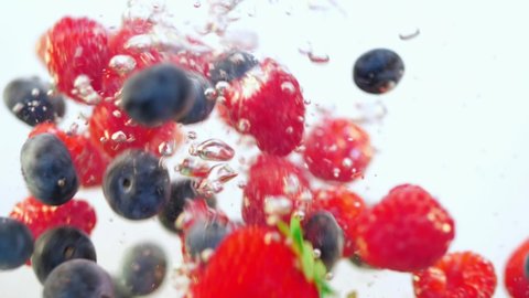 fresh berries fall into the water