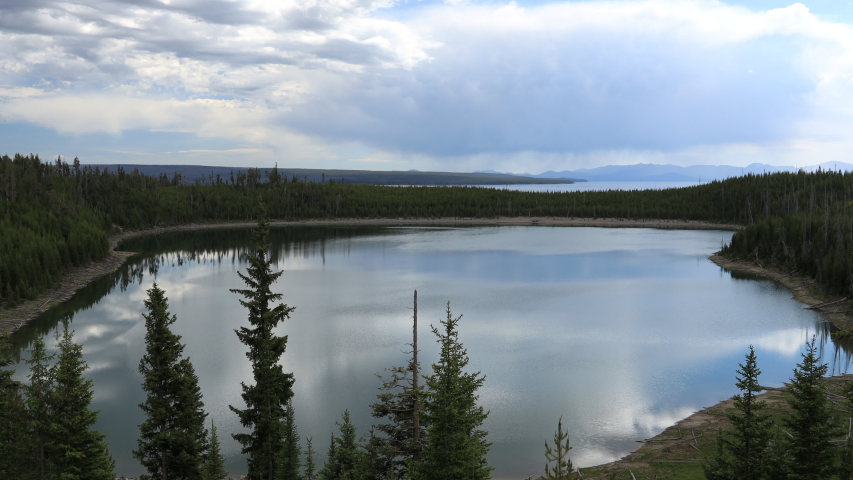 Lake at Yellowstone national park. Overcast over the lake with threes and forest