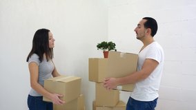 Caucasian couple have a quarrel, moving into new apartment, because don't know where to put all those big cardboard boxes.