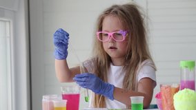 The child conducts experiments. Connects in test tubes fluids of different colors. - Powered by Shutterstock - Get 15% off with code: PIKWIZARD15