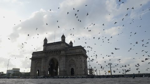 Mumbai, India: May 22, 2020: Deserted roads and very minimum traffic and crowd at Gateway of India in Mumbai due to Covid 19 pandemic lock down. Very few people moving around with masks.